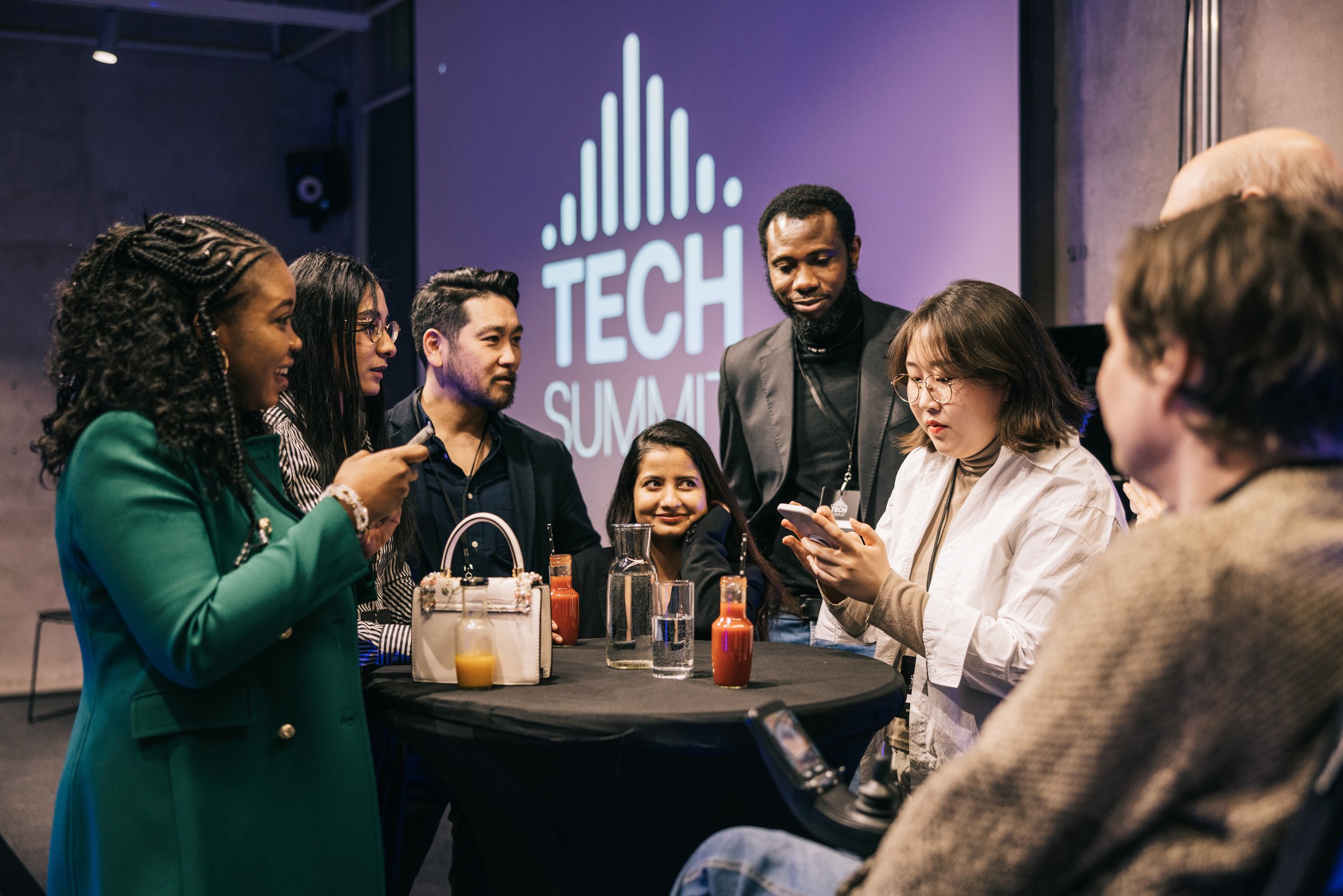 Diverse Business people mingle after successful Tech conference.